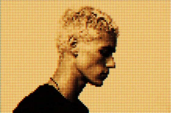 The same photograph redrawn as a grid of amber LED dots on a yellow field